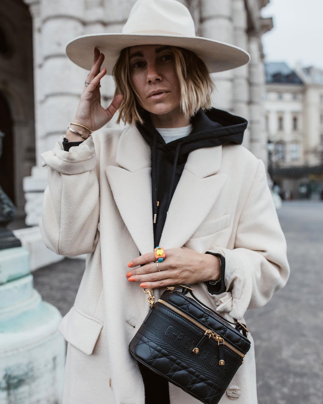 Karin Teigl wearing a Chanel bag and Gestuz coat before Mykke